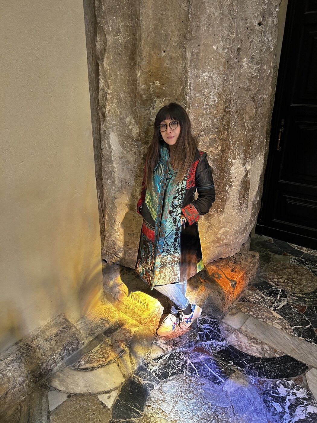 Nor Hazlin Di Prima standing beside a stone column